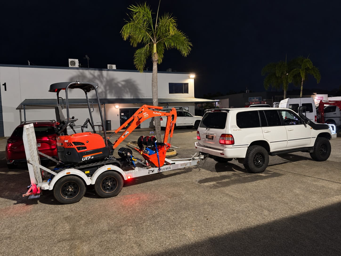 Digger2Hire Kubota U17-3 mini excavator on trailer behind LandCruiser in Brisbane